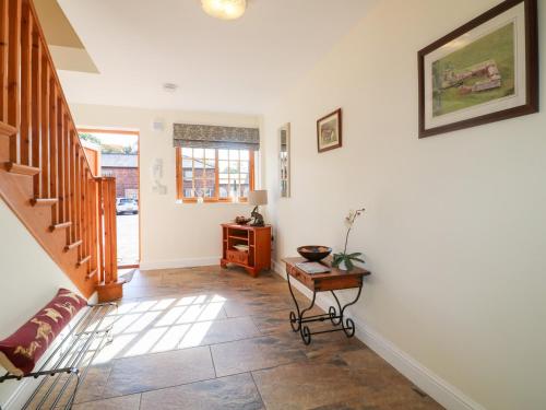 a living room with a staircase and a table at The Dairy in Nottingham