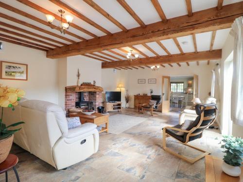 a living room with a white couch and chairs at The Dairy in Nottingham