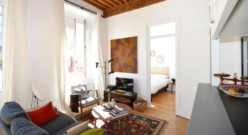 sala de estar con sofá y habitación con cama en Appart' Sainte Clotilde en Lyon