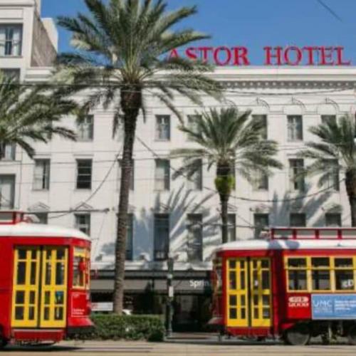 two red and yellow trolley cars in front of a hotel at Mid City Canal st 2 bedroom cute house in New Orleans