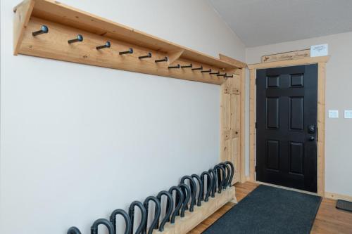 a room with a hallway with a door and a row of benches at Mama Bear in Valemount