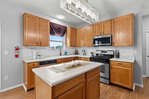 a kitchen with wooden cabinets and a white counter top at Pickerington Haven - Home for 10 in Pickerington