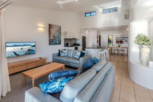 a living room with a couch and a table at Anchorage Apartments on Hamilton Island by HIHA in Hamilton Island