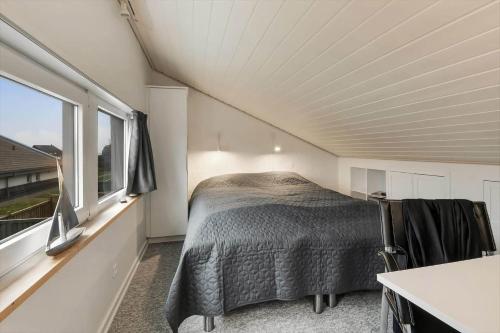 a bed in a small room with a window at C11518-Hemmet-Vester-Faelled-106-D-1 in Hemmet