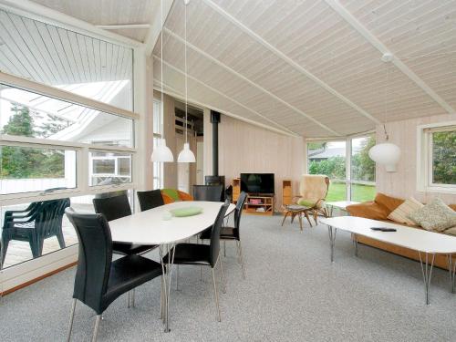 a living room with a table and chairs and a couch at 8 person holiday home in Gilleleje in Udsholt Sand