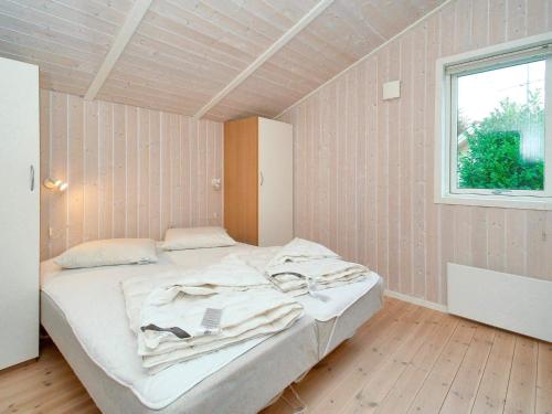 a bedroom with a bed in a room with a window at 8 person holiday home in Gilleleje in Udsholt Sand
