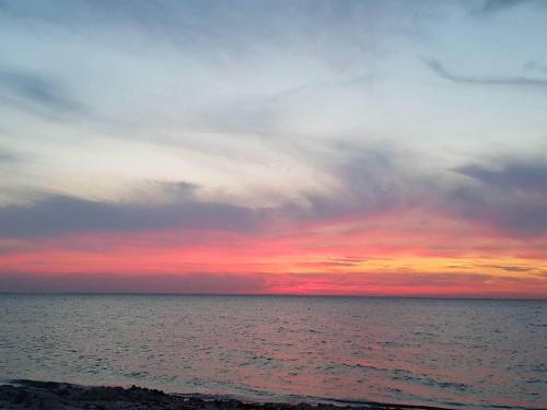 a sunset over the ocean with a cloudy sky at 6 person holiday home in Nordborg-By Traum in Nordborg