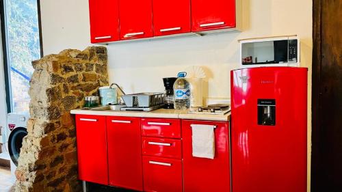 a kitchen with red cabinets and a red refrigerator at Tizapan 03 NEW 1BE&1BA in Mexico City