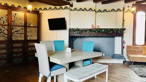 a dining room with a table and chairs and a fireplace at Tizapan 03 NEW 1BE&1BA in Mexico City