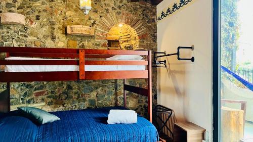 a bedroom with two bunk beds in a stone wall at Tizapan 03 NEW 1BE&1BA in Mexico City