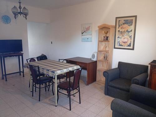 a living room with a table and chairs and a couch at Alojamiento Valle del Sol in San Fernando del Valle de Catamarca