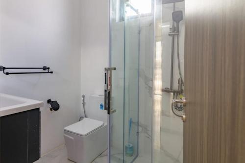 a bathroom with a toilet and a glass shower at Rocky 35 in Grand-Baie