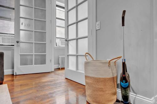 a room with a door and a basket with a bottle of wine at Modern 3BR in Gramercy -Near Union Sq NYU in New York