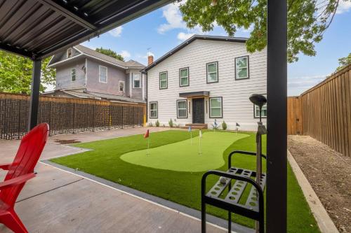 a backyard with a putting green and a house at Japandi Style 1BR Escape w EV Charger, Bishop Arts in Oak Cliff