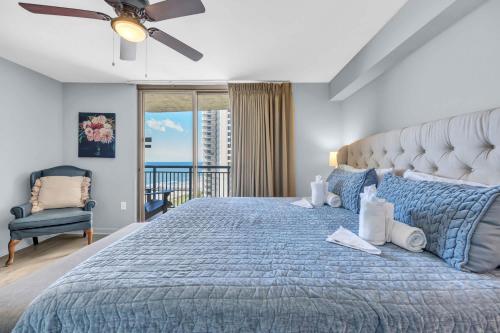 a bedroom with a bed with a blue bedspread at OCEAN VIEW PARADISE Top LOCATION & RESORT with Pool in Myrtle Beach