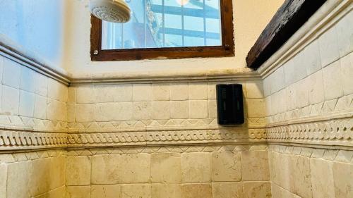 a room with a window and a brick wall at Tizapan 05 NEW 1BE&1BA in Mexico City