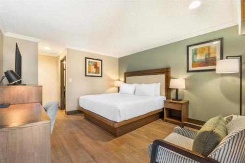 a hotel room with a bed and a tv at Best Western PLUS Burnaby Hotel in Burnaby