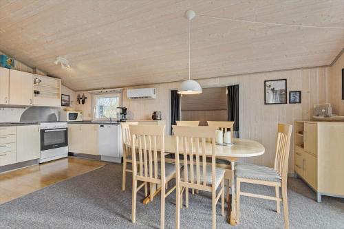 a kitchen and dining room with a table and chairs at C11216-Hemmet-Ildervej-5 in Hemmet