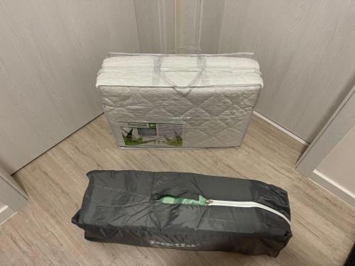 a suitcase is sitting on the floor next to a room at Well Equipped New Family Friendly One-Bedroom Flat in Sandanski