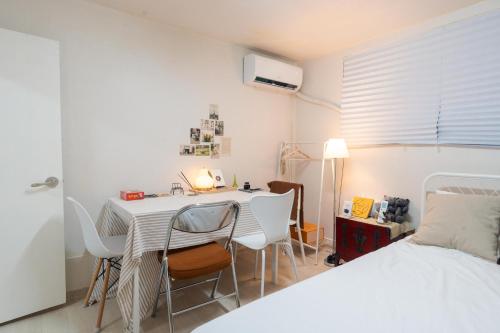 a bedroom with a table and chairs and a bed at 스타폴스테이 in Seoul