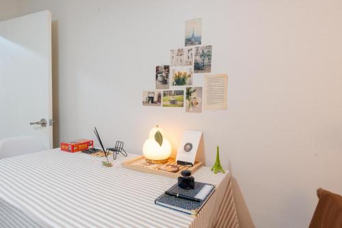 a bed with a table with a lamp on it at 스타폴스테이 in Seoul