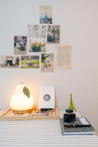 a table with a lamp and pictures on a wall at 스타폴스테이 in Seoul