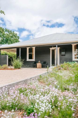 a house with a garden in front of it at The Sunday School - Timeless Cottage Wine Region in Red Hill