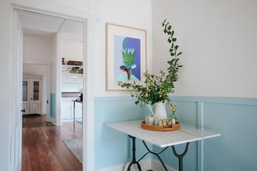 雷德山The Sunday School - Timeless Cottage Wine Region的一间有桌子的房间,上面有植物