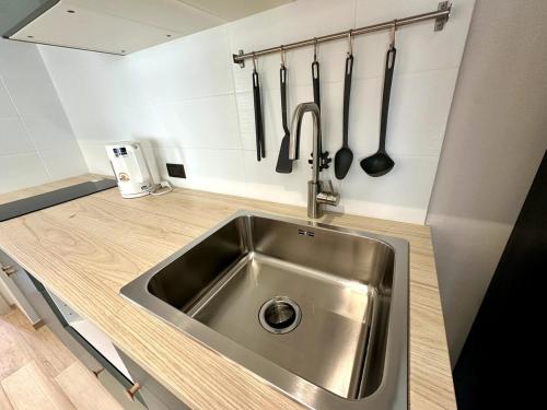 a kitchen with a stainless steel sink and utensils at Beatiful titlhalo apartment in Nai Yang Beach