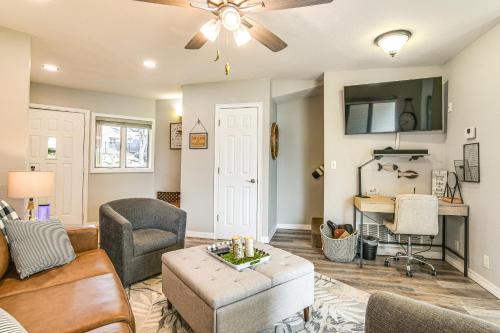a living room with a couch and a table at Table Rock Lake Retreat Steps to Water and Pools! in Kimberling City
