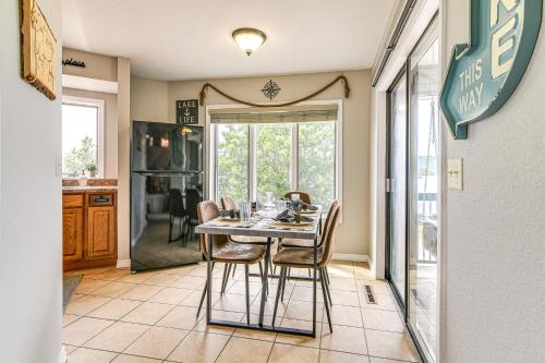 a kitchen and dining room with a table and chairs at Table Rock Lake Retreat Steps to Water and Pools! in Kimberling City