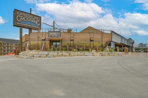 a building with a sign in the middle of a street at Table Rock Lake Retreat Steps to Water and Pools! in Kimberling City