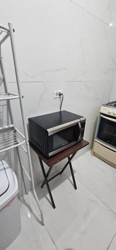 a microwave sitting on a table in a kitchen at Discovery Beach Apartments in Aguada