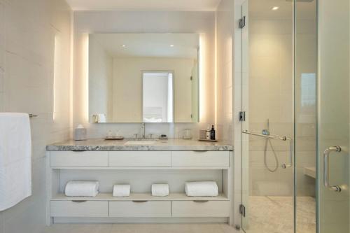 a bathroom with a sink and a shower with a mirror at St. Regis Bahia Beach Resort, Puerto Rico in Rio Grande