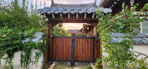 an entrance to a house with a wooden gate at Jahayeon Hanokstay in Jeonju