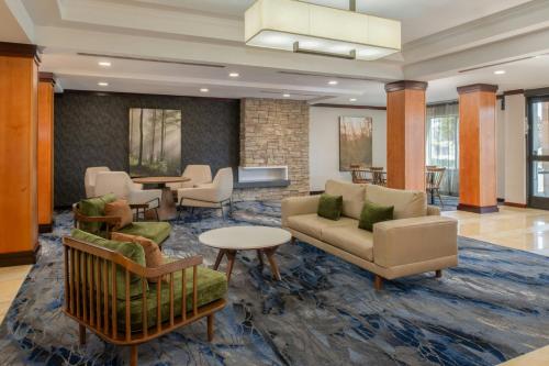 a lobby with a couch and chairs and tables at Fairfield Inn & Suites Santa Maria in Santa Maria