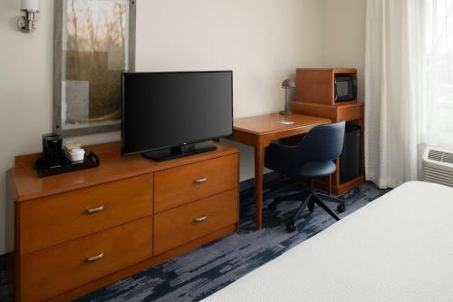 a bedroom with a desk and a television on a dresser at Fairfield Inn & Suites Santa Maria in Santa Maria