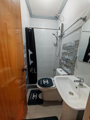 a small bathroom with a toilet and a sink at Grace Abode Haven in General Santos