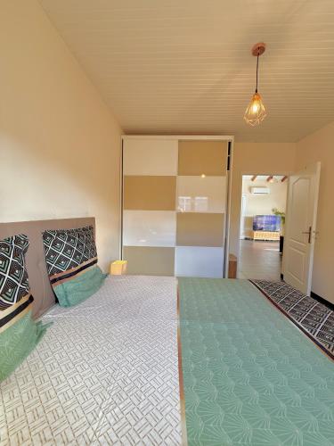 a bedroom with a large bed in a room at Villa SAADA cosy avec piscine, jacuzzi et sauna in Le Vauclin