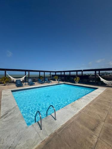 a swimming pool on top of a building at Suite vista mar marinas cabo branco in João Pessoa