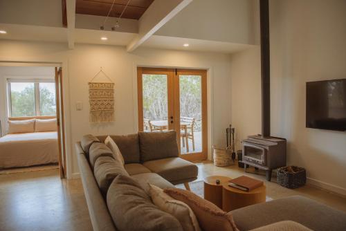 a living room with a couch and a stove at Sea Loft Kangaroo Island in Kingscote