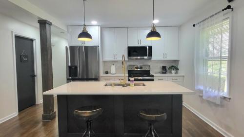 a kitchen with a large island with two bar stools at Entire house in Old Town Lilburn 4 bedrooms 4 bath in Lilburn
