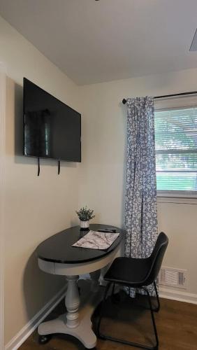 a room with a table and a chair and a window at Entire house in Old Town Lilburn 4 bedrooms 4 bath in Lilburn