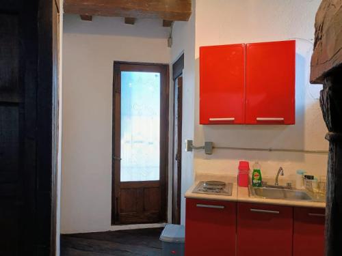 a kitchen with red cabinets and a sink at Tizapan 01 NEW 1BE&1BA in Mexico City