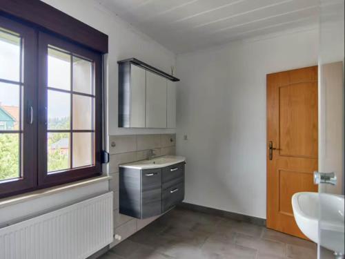 a bathroom with a sink and a mirror at Haus Freigeist - Friedrichssuite in Neinstedt