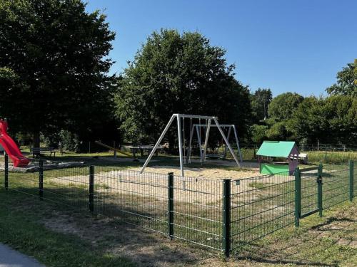 an empty playground with a swing set in a park at Idyllic holiday apartment in Lübberstedt