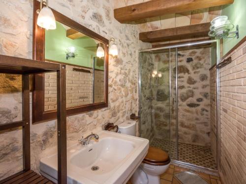 a bathroom with a sink and a shower and a toilet at Mas De Rogelio in Beceite