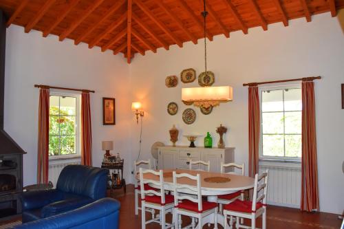 a living room with a table and a blue couch at Outeiro do Álamo by Portus Alacer in Cabeço de Vide