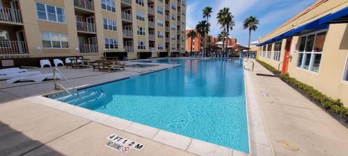 a swimming pool with blue water in a building at Private Beach Access Pool & Hot Tub BBQ Pits Gulfview II #408 home in South Padre Island