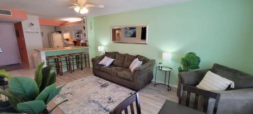 a living room with a couch and a table at Private Beach Access Pool & Hot Tub BBQ Pits Gulfview II #408 home in South Padre Island